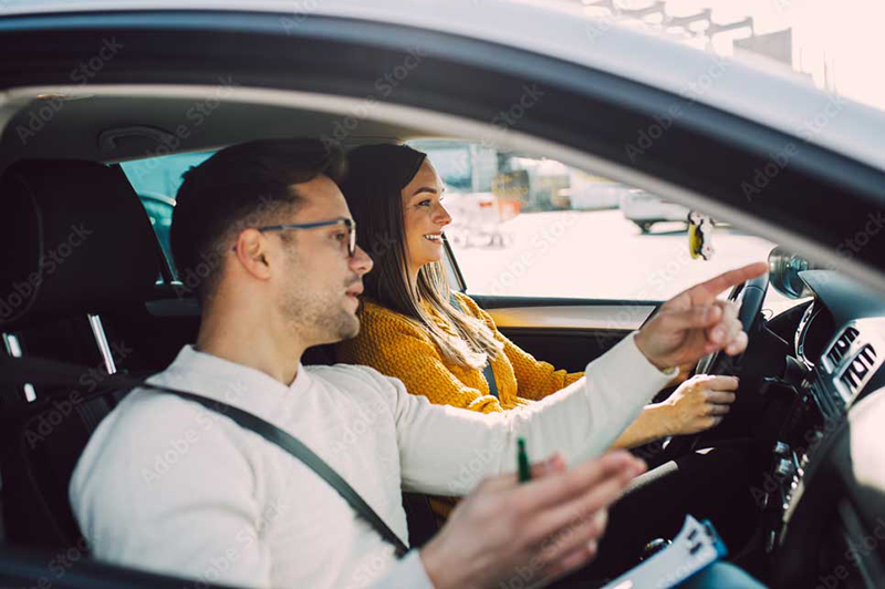 A skilled driving instructor providing guidance to a student during a road test, showcasing the platform's connection between instructors and students on Road-Test.ca.