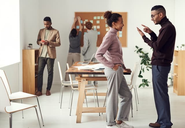 An image of a bustling office space with dedicated individuals working together, representing the passionate team behind Road-Test.ca. Their commitment to connecting individuals with suitable cars, instructors, and driving schools near their location is evident in their exceptional customer service and industry expertise.